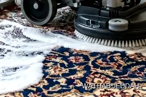 فريق وثاب جدة أثناء تنظيف سجاد في حي البوادي بجدة